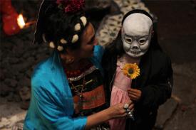 Film still for Two Fridas: woman and little girl in a skull mask
